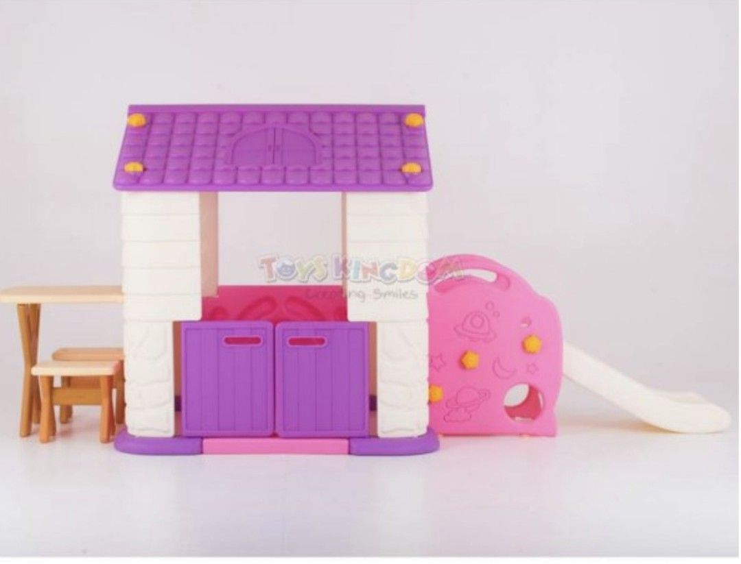 Eduplay Playhouse with Slide (Category: Infant Playtime) located in Manila. Submitted by declutterbabythings (Listing ID 1409758040, Image 1). Description: Eduplay playhouse features a slide and a small table with two chairs. The playhouse has a purple roof and door, with a white and purple body. The slide is pink and white. The playhouse is suitable for children..