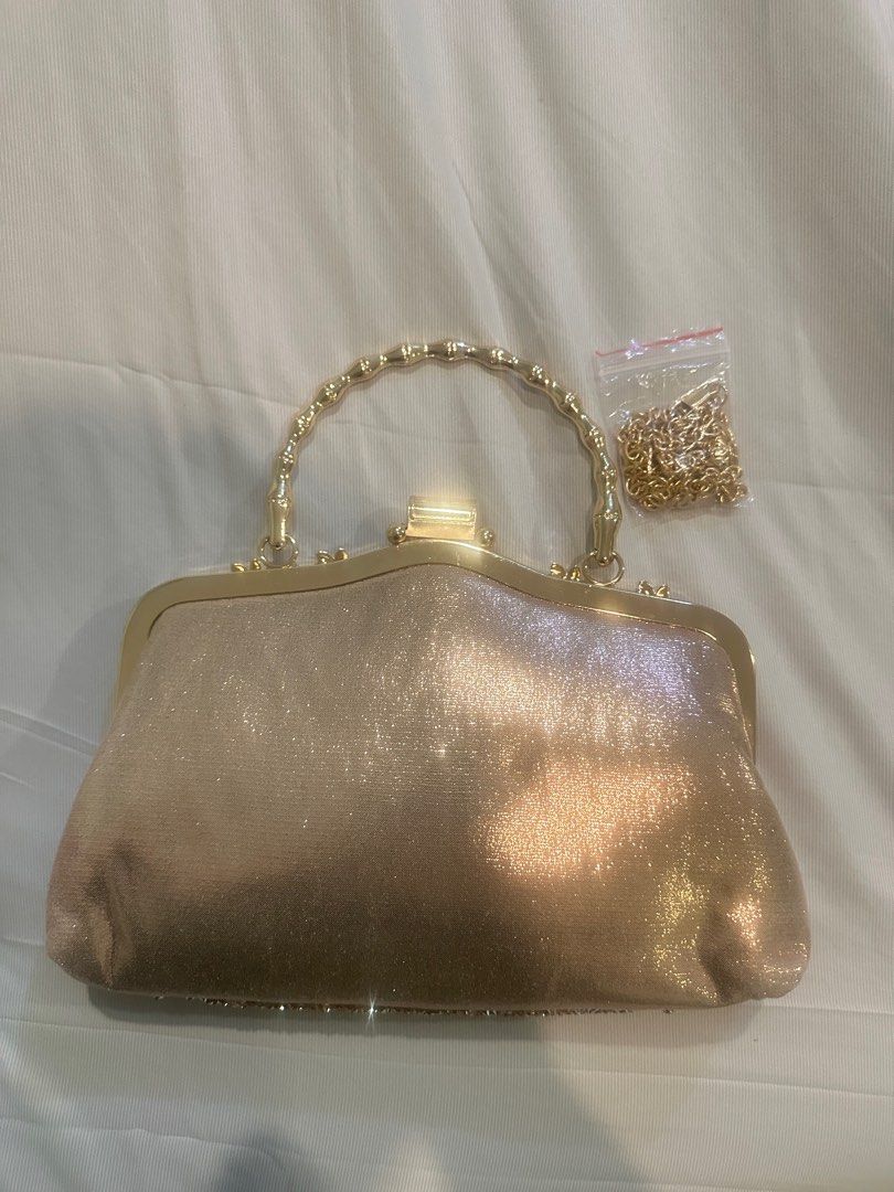 Gold Embellished Clutch Bag with Chain (Category: Clutches) located in Manila. Submitted by brielliant (Listing ID 1409659846, Image 2). Description: - Gold clutch bag - Intricate embellishments - Gold handle and detachable chain - Matching gold fabric lining - Secure clasp closure - Perfect for special occasions Used once in a party It can fit a lot of items Pls TEXT message me if urgent or going to get it na. I dont usually see the notications 