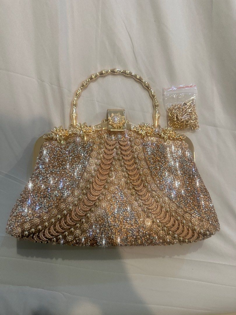 Gold Embellished Clutch Bag with Chain (Category: Clutches) located in Manila. Submitted by brielliant (Listing ID 1409659846, Image 1). Description: - Gold clutch bag - Intricate embellishments - Gold handle and detachable chain - Matching gold fabric lining - Secure clasp closure - Perfect for special occasions Used once in a party It can fit a lot of items Pls TEXT message me if urgent or going to get it na. I dont usually see the notications 