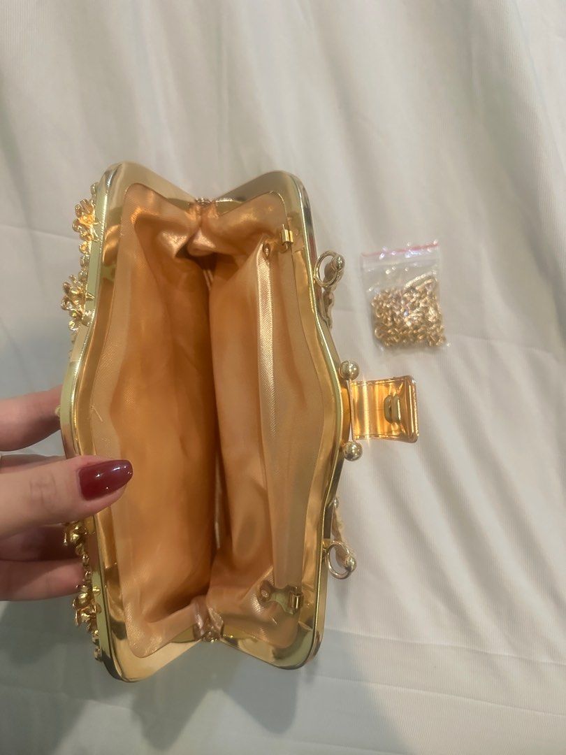 Gold Embellished Clutch Bag with Chain (Category: Clutches) located in Manila. Submitted by brielliant (Listing ID 1409659846, Image 3). Description: - Gold clutch bag - Intricate embellishments - Gold handle and detachable chain - Matching gold fabric lining - Secure clasp closure - Perfect for special occasions Used once in a party It can fit a lot of items Pls TEXT message me if urgent or going to get it na. I dont usually see the notications 