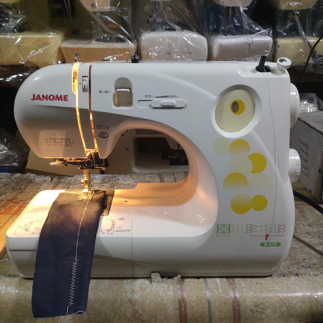 Janome Sewing Machine N-572 (Category: Craft Supplies & Tools) located in Manila. Submitted by faststone-c3c8 (Listing ID 1409688350, Image 2). Description: - Janome N-572 sewing machine - In good working condition - Features a built-in light - Offers various stitch settings - Color: White with yellow accents - Model number visible.