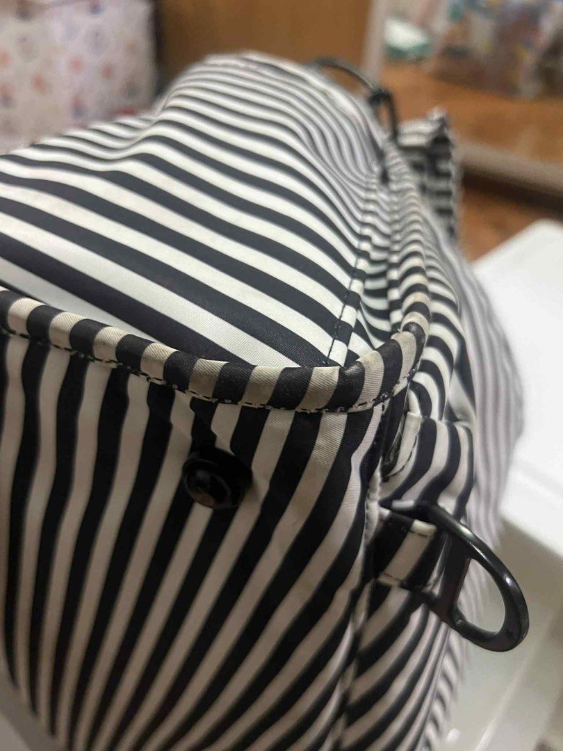 JuJuBe Black and White Stripe Diaper Bag (Category: Diaper Bags & Wetbags) located in Antipolo. Submitted by puzzleaddict (Listing ID 1409729955, Image 3). Description: - JuJuBe diaper bag - Black and white stripes - Multiple compartments and zippers - Front pocket - Striped interior - Black hardware - Top handle - Shows wear and discoloration on edges and zippers.
