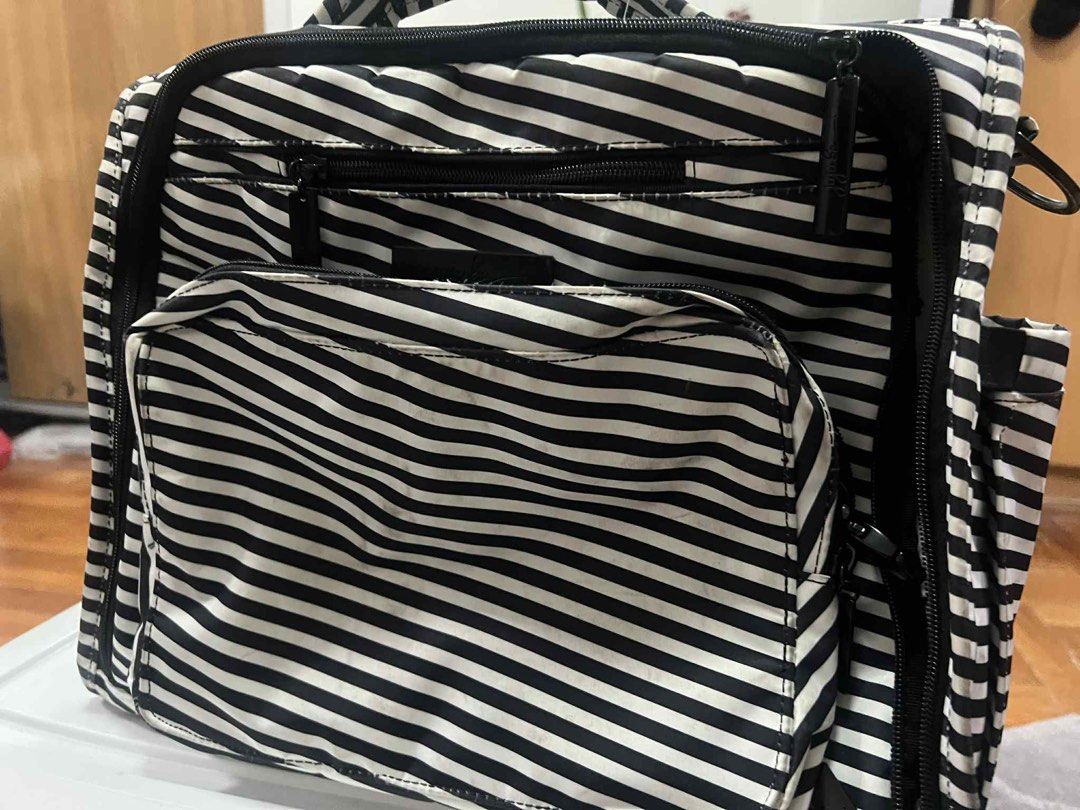 JuJuBe Black and White Stripe Diaper Bag (Category: Diaper Bags & Wetbags) located in Antipolo. Submitted by puzzleaddict (Listing ID 1409729955, Image 2). Description: - JuJuBe diaper bag - Black and white stripes - Multiple compartments and zippers - Front pocket - Striped interior - Black hardware - Top handle - Shows wear and discoloration on edges and zippers.