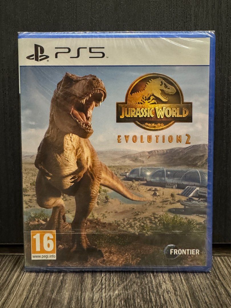 Jurassic World Evolution 2 - PS5 (Category: PlayStation) located in Singapore. Submitted by riamaz (Listing ID 1409700607, Image 1). Description: - Brand new and sealed game - Jurassic World Evolution 2 for PlayStation 5 - Perfect for fans of Jurassic Park - Build and manage your own dinosaur park.