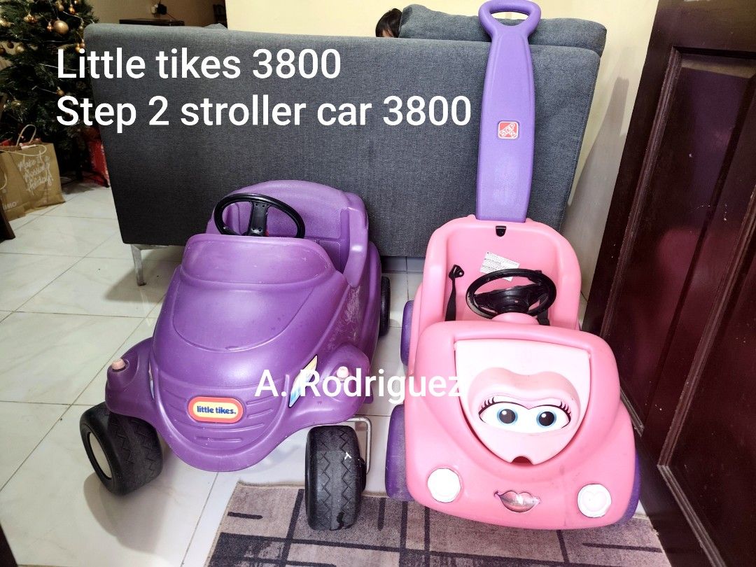 Little Tikes Step 2 Stroller Car (Category: Infant Playtime) located in Manila. Submitted by declutterbabythings (Listing ID 1409758420, Image 2). Description: Listing includes a Little Tikes and a Step 2 stroller car. The pink car has a steering wheel and a seatbelt. The purple car has a steering wheel. Both cars are designed for children. The Step 2 car has a handle for pushing. The price for each car is 3800..