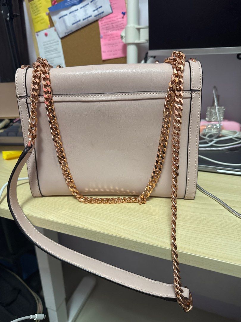 Michael Kors Studded Shoulder Bag (Category: Luxury Bags & Wallets) located in Manila. Submitted by franzescaaaa (Listing ID 1409729101, Image 3). Description: - Michael Kors shoulder bag - Blush pink exterior - Gold-tone star and heart studs - Chain strap - Flap closure with Michael Kors logo - Interior zippered pocket - Perfect for everyday use.