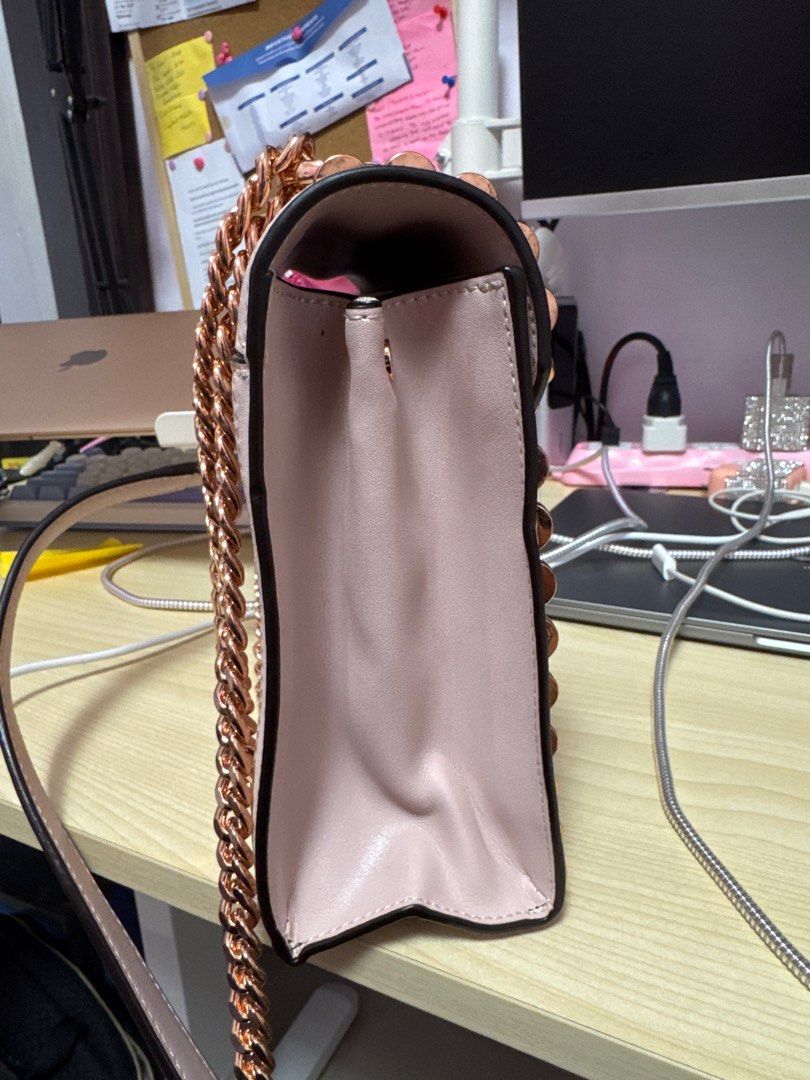 Michael Kors Studded Shoulder Bag (Category: Luxury Bags & Wallets) located in Manila. Submitted by franzescaaaa (Listing ID 1409729101, Image 2). Description: - Michael Kors shoulder bag - Blush pink exterior - Gold-tone star and heart studs - Chain strap - Flap closure with Michael Kors logo - Interior zippered pocket - Perfect for everyday use.