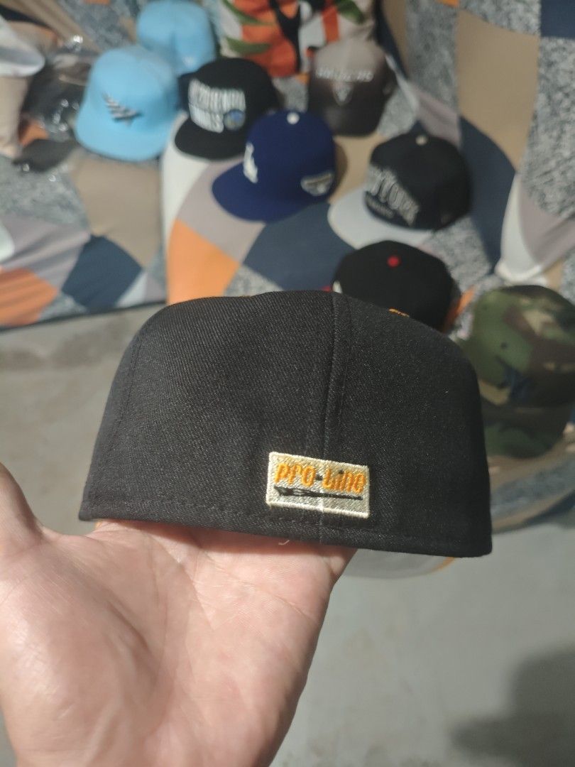 Pro-Line Cap (Category: Caps & Hats) located in San Jose del Monte. Submitted by authenticeraph (Listing ID 1409753454, Image 2). Description: - Pro-Line cap - Black crown - Orange brim - Orange "TU" logo on front - Pro-Line tag at the back - Size 7 - Black interior with orange stitching.
