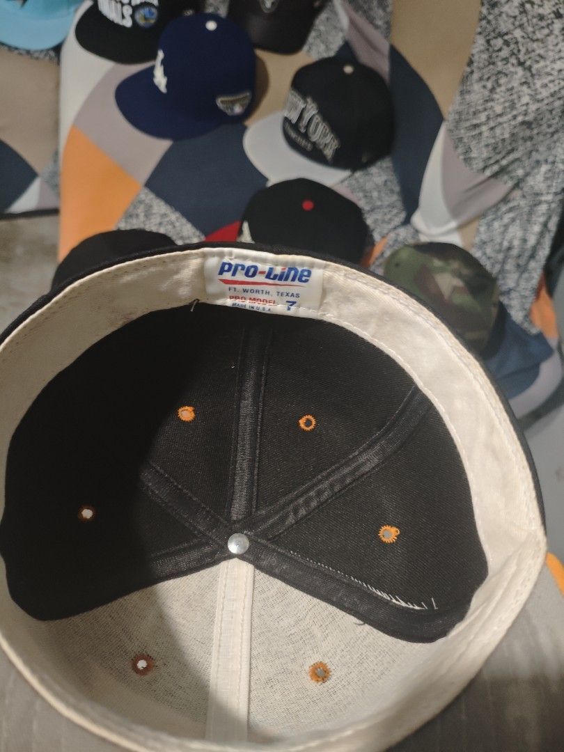 Pro-Line Cap (Category: Caps & Hats) located in San Jose del Monte. Submitted by authenticeraph (Listing ID 1409753454, Image 3). Description: - Pro-Line cap - Black crown - Orange brim - Orange "TU" logo on front - Pro-Line tag at the back - Size 7 - Black interior with orange stitching.