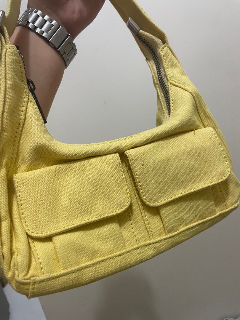 Yellow Shoulder Bag (Category: Shoulder Bags) located in Manila. Submitted by ragssurplus (Listing ID 1409621934, Image 3). Description: - REGEN shoulder bag in yellow - Two front pockets - Zippered main compartment - Black interior - Canvas-like material - Shoulder strap included - Small flap with magnetic closure.
