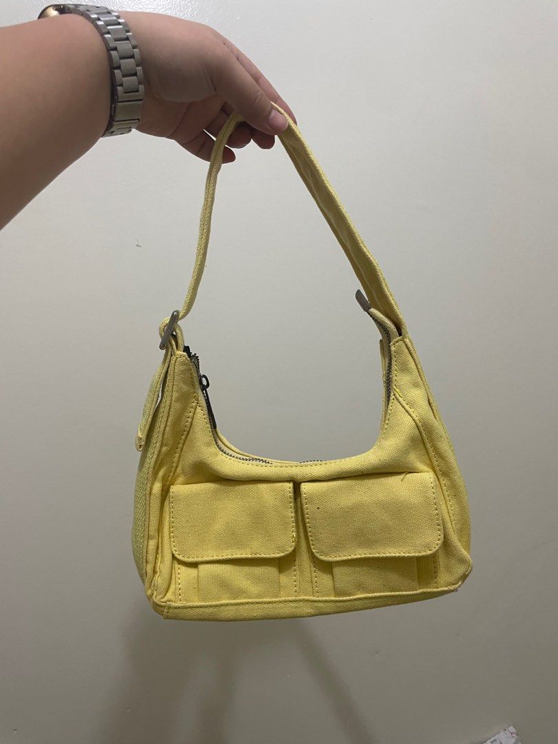 Yellow Shoulder Bag (Category: Shoulder Bags) located in Manila. Submitted by ragssurplus (Listing ID 1409621934, Image 1). Description: - REGEN shoulder bag in yellow - Two front pockets - Zippered main compartment - Black interior - Canvas-like material - Shoulder strap included - Small flap with magnetic closure.