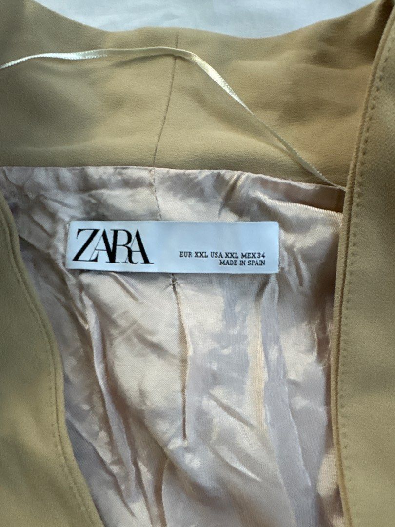 Zara Blazer - Beige (Category: Coats, Jackets and Outerwear) located in Quezon City. Submitted by authentic_c (Listing ID 1409672855, Image 2). Description: Beige blazer from Zara. Features a classic design with two front pockets. The blazer is a size XXL and made in Spain. It has a tailored fit and a neutral color, making it versatile for various outfits. The blazer is suitable for both casual and semi-formal occasions..