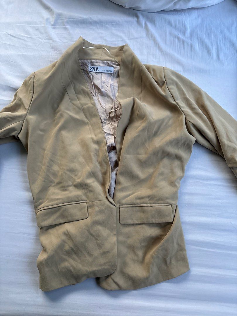 Zara Blazer - Beige (Category: Coats, Jackets and Outerwear) located in Quezon City. Submitted by authentic_c (Listing ID 1409672855, Image 1). Description: Beige blazer from Zara. Features a classic design with two front pockets. The blazer is a size XXL and made in Spain. It has a tailored fit and a neutral color, making it versatile for various outfits. The blazer is suitable for both casual and semi-formal occasions..