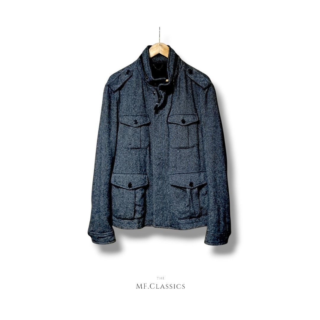 Zara Man Wool Military Jacket (Gray) (Category: Coats, Jackets and Outerwear) located in Manila. Submitted by mf.classics (Listing ID 1409745273, Image 1). Description: Stylish Zara Man jacket. Features a textured tweed fabric in a grey color. It has multiple pockets, a zip and button closure, and a stand-up collar. The jacket is a size XL. Made in China. Perfect for adding a touch of sophistication to your wardrobe. Measurements: 26 L 21 W.