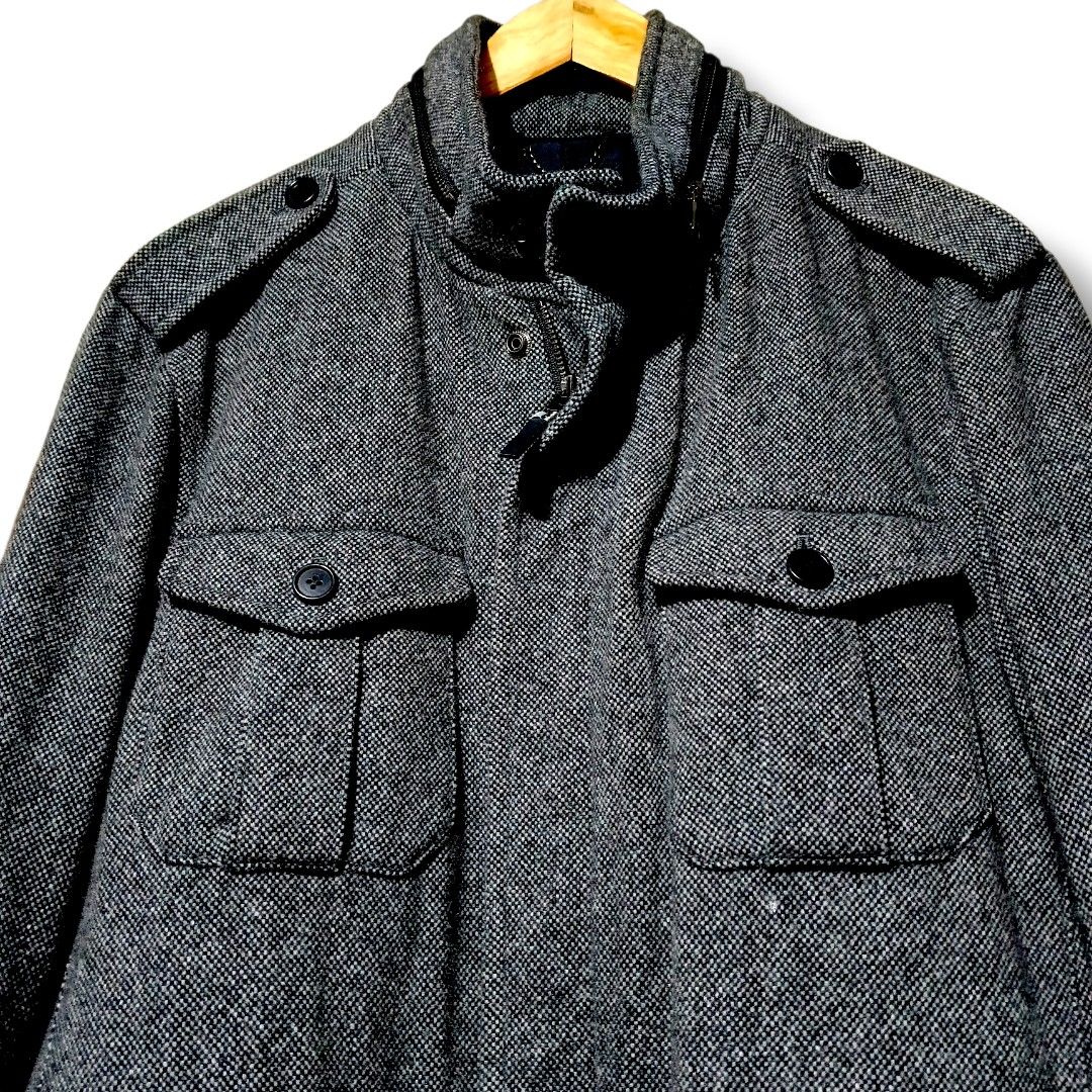 Zara Man Wool Military Jacket (Gray) (Category: Coats, Jackets and Outerwear) located in Manila. Submitted by mf.classics (Listing ID 1409745273, Image 2). Description: Stylish Zara Man jacket. Features a textured tweed fabric in a grey color. It has multiple pockets, a zip and button closure, and a stand-up collar. The jacket is a size XL. Made in China. Perfect for adding a touch of sophistication to your wardrobe. Measurements: 26 L 21 W.