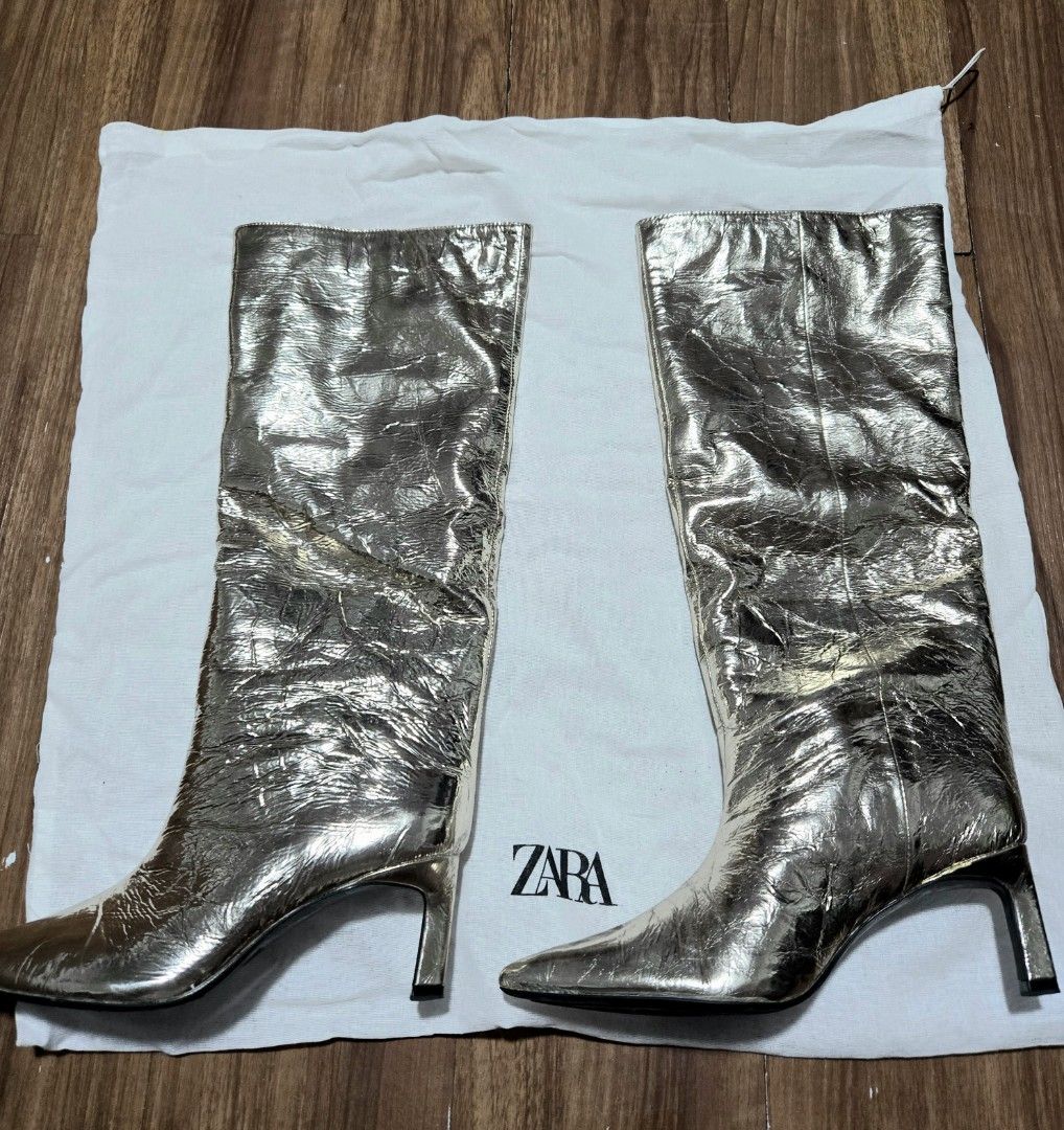 Zara Metallic Knee High Boots size 36 (Category: Boots) located in Quezon City. Submitted by bk2025 (Listing ID 1409786842, Image 2). Description: - Zara metallic knee-high boots - Pointed toe - Mid-height heel - Includes Zara dust bag - Unique textured metallic finish - Zara logo on sole.