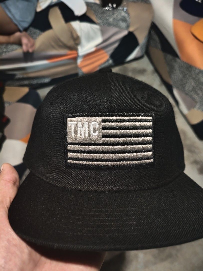 Black Caps with Various Designs (Category: Caps & Hats) located in San Jose del Monte. Submitted by authenticeraph (Listing ID 1409878699, Image 2). Description: - Black caps collection - Designs include: - "VL" logo - "TMC" with American flag - "VICTORY" embroidery - "TMC" in a wreath - "M" - "Gershaw" embroidery.