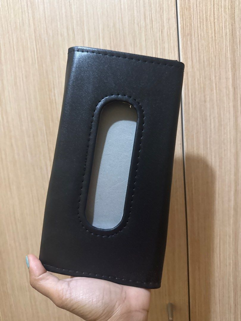 Black Leather Tissue Box Holder (Category: Storage Boxes & Baskets) located in Manila. Submitted by bblenshop (Listing ID 1409974895, Image 1). Description: - Black leather tissue box holder - Rectangular shape - Features a cutout for tissue dispensing - Flap closure on the back - Smooth leather material - Visible stitching detail.