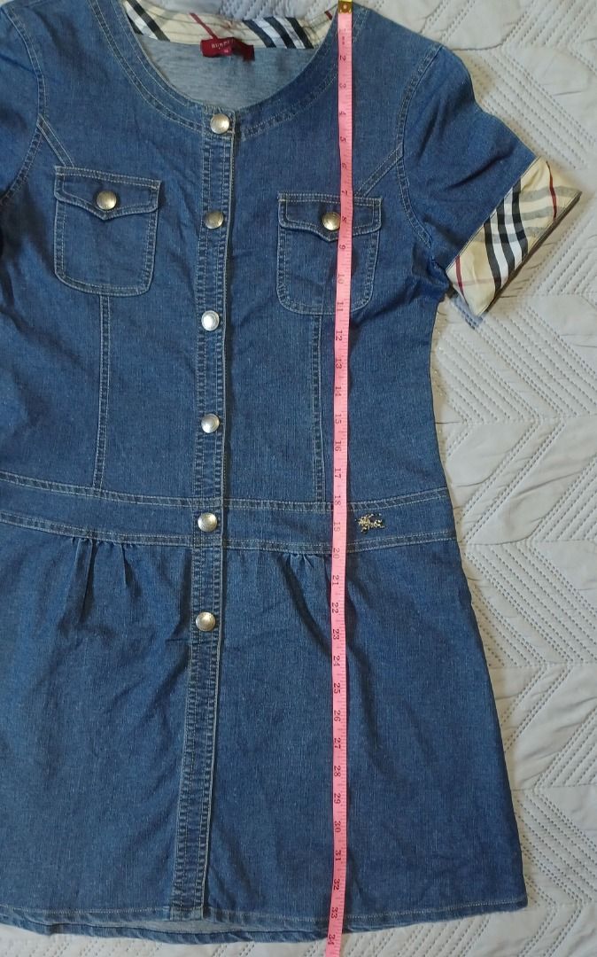 Burberry Denim Dress (Category: Dresses) located in Pasig City. Submitted by Magdythrift23 (Listing ID 1409917119, Image 3). Description: - Authentic Burberry denim dress - Size: XL - Button-down front - Short sleeves - Burberry check pattern on collar and cu - Denim material.