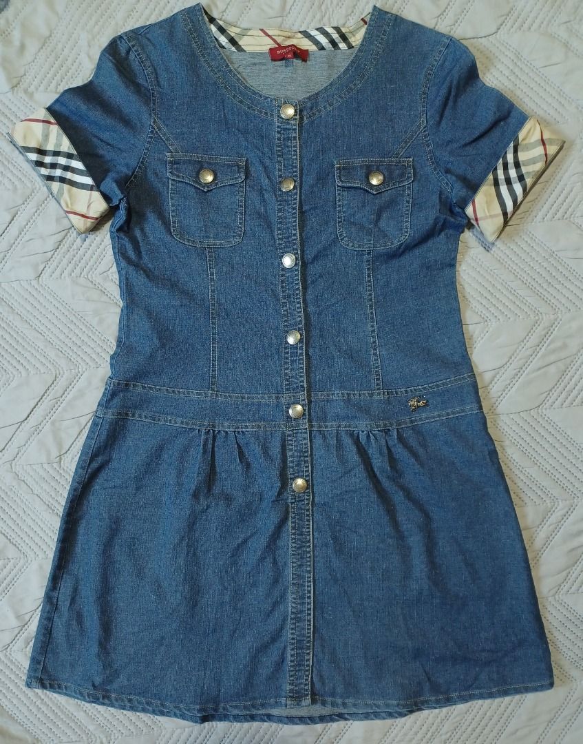 Burberry Denim Dress (Category: Dresses) located in Pasig City. Submitted by Magdythrift23 (Listing ID 1409917119, Image 1). Description: - Authentic Burberry denim dress - Size: XL - Button-down front - Short sleeves - Burberry check pattern on collar and cu - Denim material.