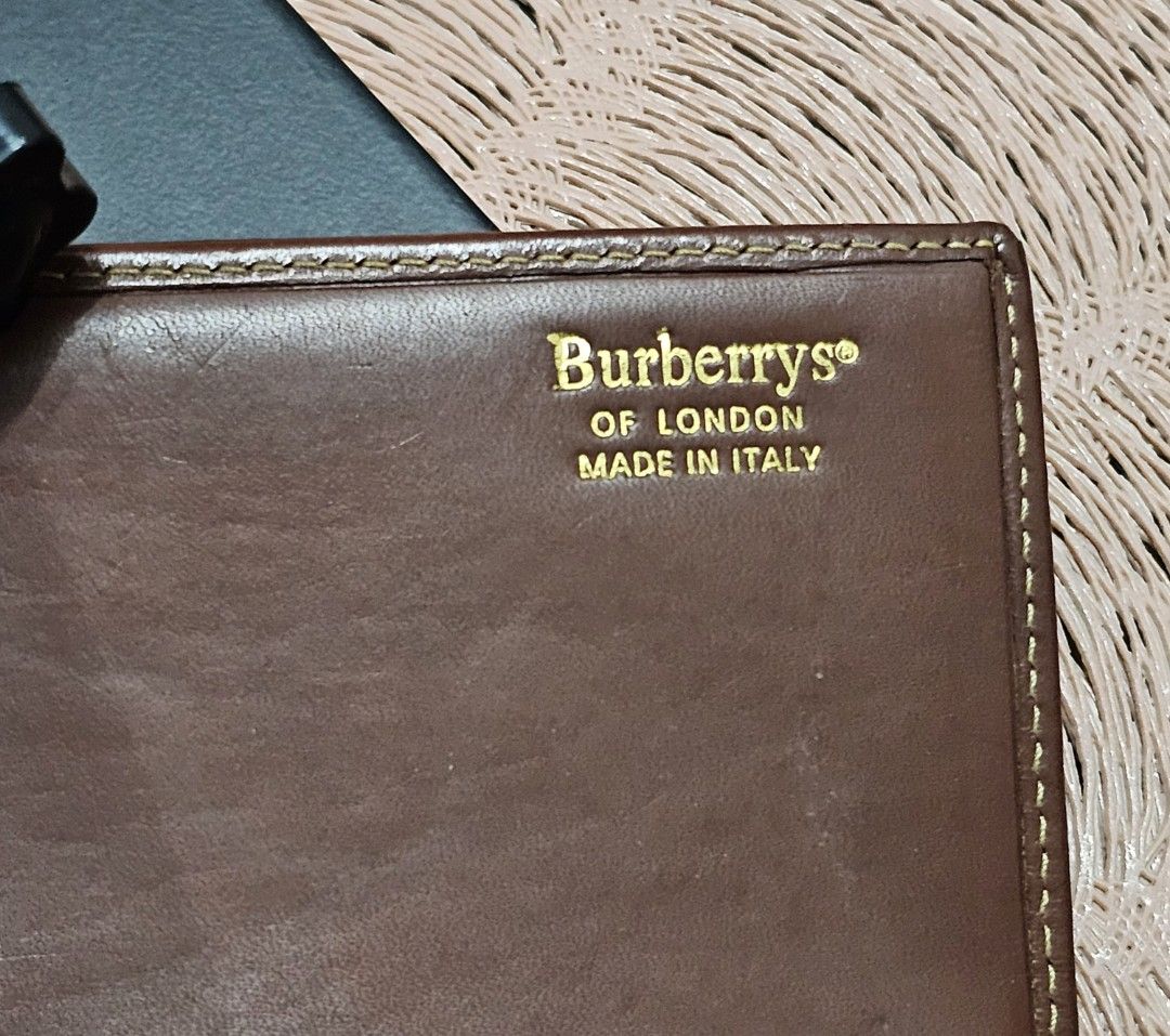 Burberrys trifold long wallet (Category: Luxury Bags & Wallets) located in Caloocan City. Submitted by e_o62059 (Listing ID 1409990659, Image 2). Description: - Authentic Burberrys of London wallet - Classic checkered pattern - Brown leather trim - Made in Italy - Multiple card slots - Zippered compartment - Clear ID window - Snap closure - Coin pocket - Brown fabric lining - very clean and ready to use -no issues nor damages.