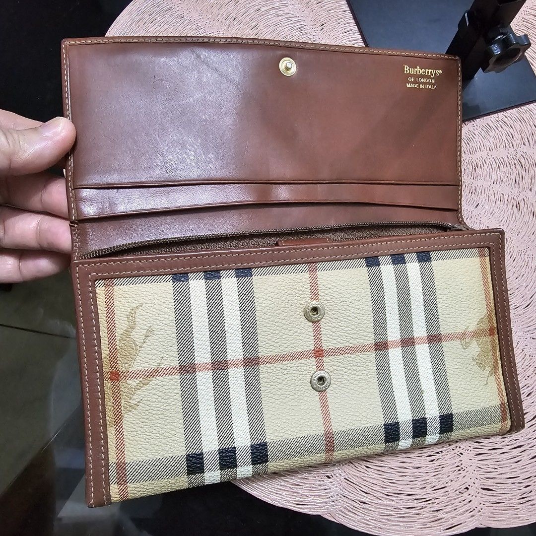 Burberrys trifold long wallet (Category: Luxury Bags & Wallets) located in Caloocan City. Submitted by e_o62059 (Listing ID 1409990659, Image 3). Description: - Authentic Burberrys of London wallet - Classic checkered pattern - Brown leather trim - Made in Italy - Multiple card slots - Zippered compartment - Clear ID window - Snap closure - Coin pocket - Brown fabric lining - very clean and ready to use -no issues nor damages.