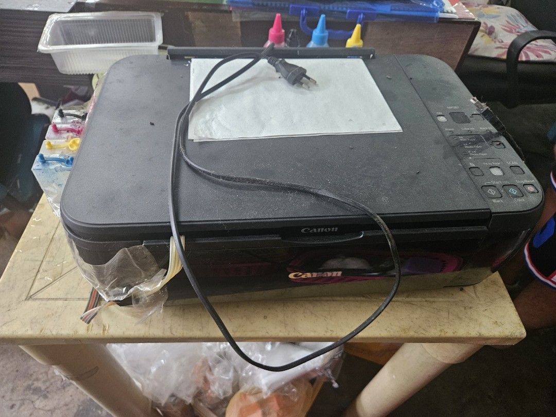 Canon PIXMA MP250 Inkjet Printer (Category: Printers, Scanners & Copiers) located in Caloocan City. Submitted by eunicegerm80358 (Listing ID 1409817002, Image 1). Description: - Canon PIXMA MP250 inkjet printer - External ink tank system included - Comes with ink bottles - Includes power cable - In working condition - Features a flatbed scanner - Color: Black -need to change external ink tank system because clogged - barely used and got a new one