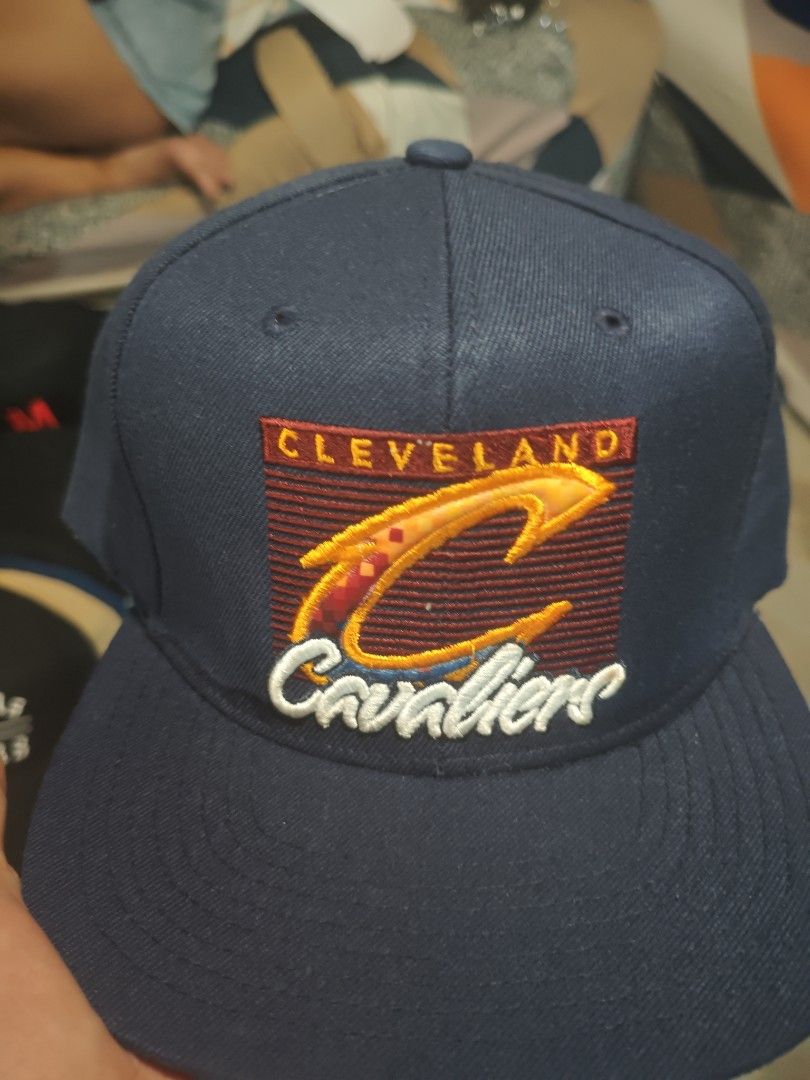 Cleveland Cavaliers Cap (Category: Caps & Hats) located in San Jose del Monte. Submitted by authenticeraph (Listing ID 1409863578, Image 1). Description: - Navy blue Cleveland Cavaliers cap - Team logo on the front - Mitchell & Ness logo on the underside of the brim.