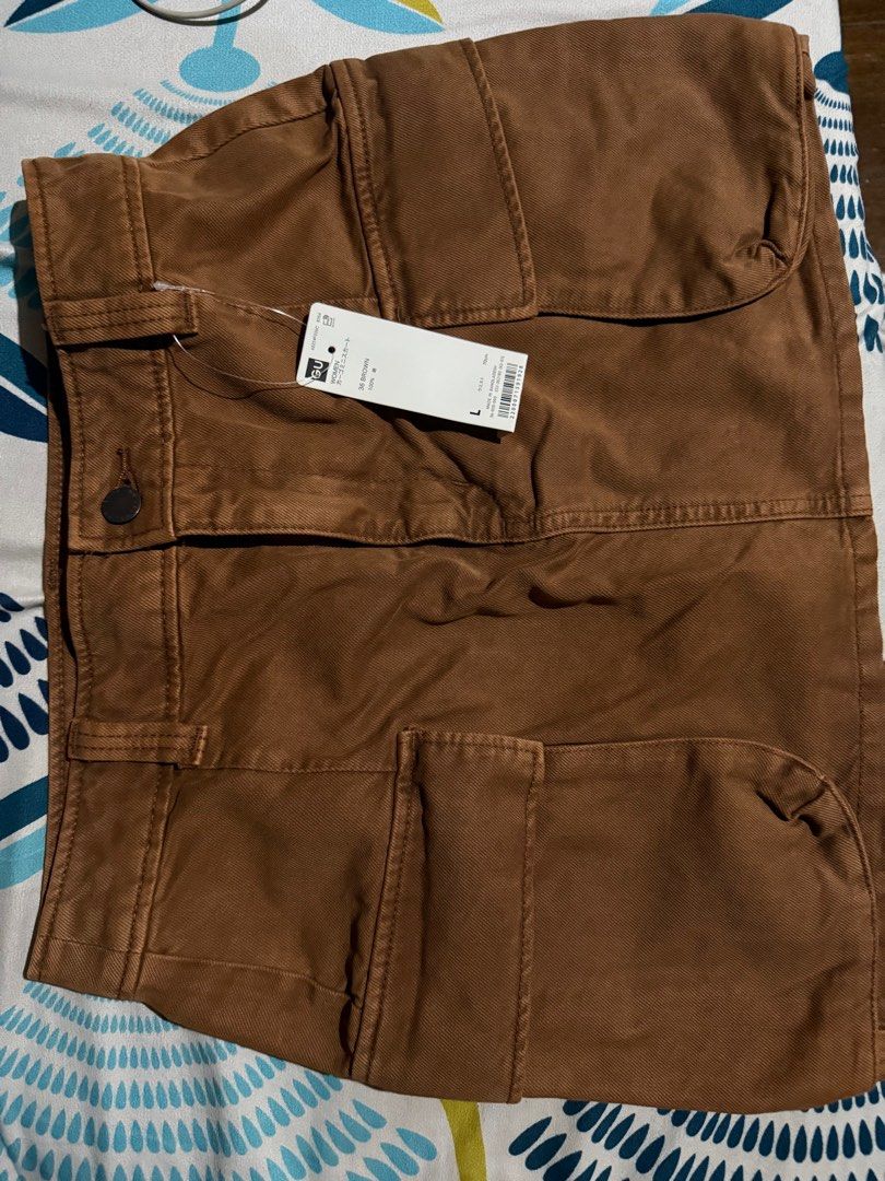 GU Brown Cargo Skirt - Size L (Category: Other Bottoms) located in Manila. Submitted by chrylpmlpj (Listing ID 1409926374, Image 1). Description: - Brand: GU - Style: Cargo Skirt - Color: Brown - Size: L, waist 29 inches - Condition: New with tags - Features: Multiple pockets, button closure - Location: Sampaloc, Manila or Diliman, QC.