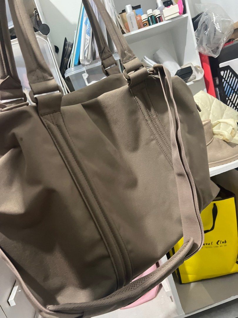 Herschel Supply Co. Tote Bag (Category: Tote Bags) located in Bocaue. Submitted by janishoppe (Listing ID 1409889411, Image 3). Description: - Herschel Supply Co. tote bag - Neutral brown color - Main compartment with red and white striped lining - Multiple interior pockets - Detachable shoulder strap - Top handles - Front pocket - Herschel Supply Co. logo patch.