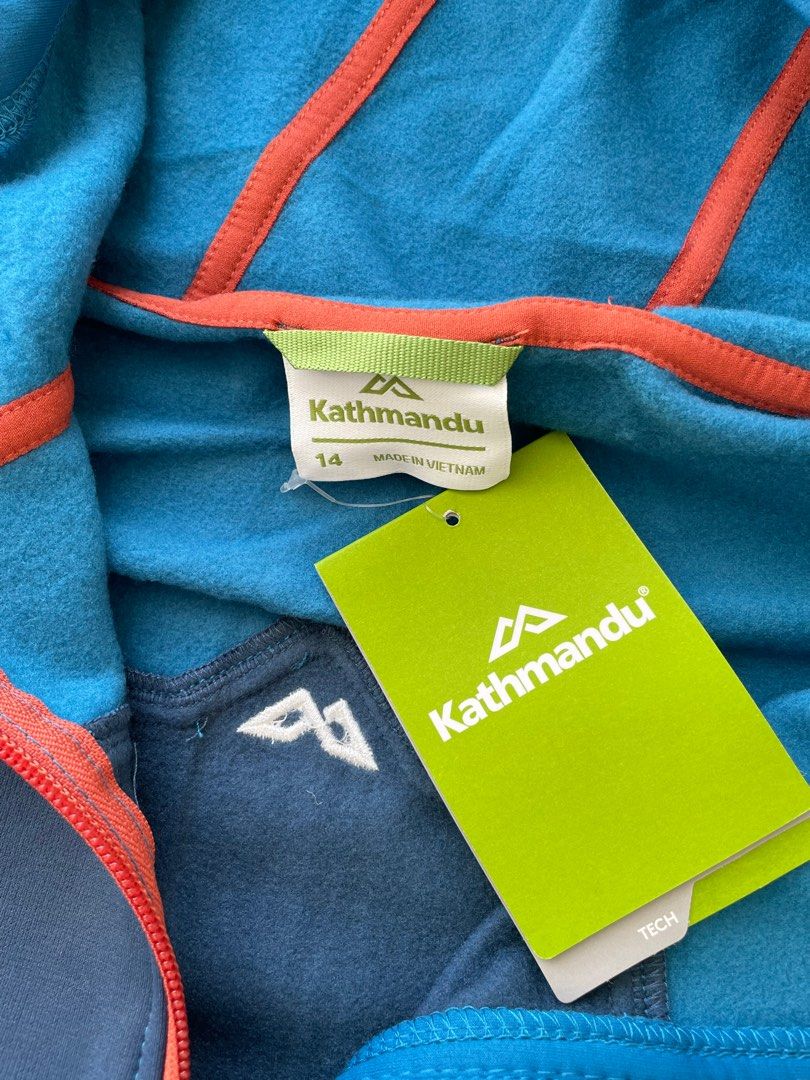 Kathmandu Hooded Jacket Size 14 (Category: Coats, Jackets and Outerwear) located in Manila. Submitted by winnieyols (Listing ID 1409863752, Image 1). Description: KATHMANDU ( NEW ZEALAND APPAREL BRAND ) - BRANDNEW / bought in NEW ZEALAND - ORIGINAL Kathmandu hooded jacket in blue and navy. SIZE : UK 14 Features a full zip closure, two front pockets, and a hood with a drawstring. The jacket has orange accents and the Kathmandu logo on the chest. -
