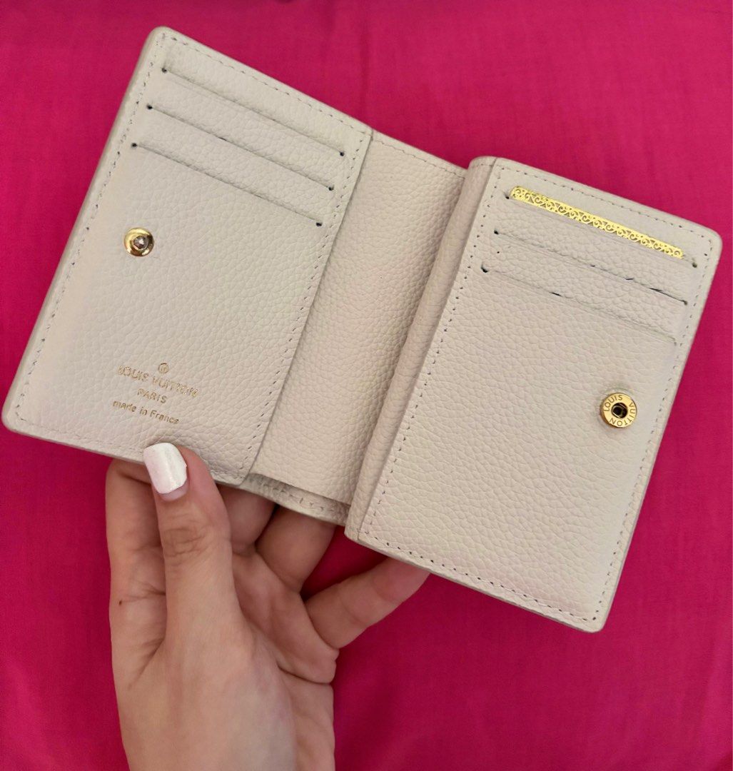 Louis Vuitton Pink White Compact Wallet (Category: Luxury Bags & Wallets) located in Cavite. Submitted by clydeachilles (Listing ID 1409814002, Image 3). Description: - Louis Vuitton Pink White Wallet - Compact size - Multiple card slots - Coin compartment - Snap closure - Zipper closure - Neutral color - Textured finish - Gold accents.