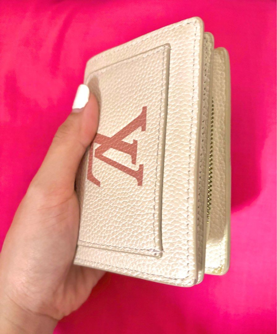 Louis Vuitton Pink White Compact Wallet (Category: Luxury Bags & Wallets) located in Cavite. Submitted by clydeachilles (Listing ID 1409814002, Image 2). Description: - Louis Vuitton Pink White Wallet - Compact size - Multiple card slots - Coin compartment - Snap closure - Zipper closure - Neutral color - Textured finish - Gold accents.