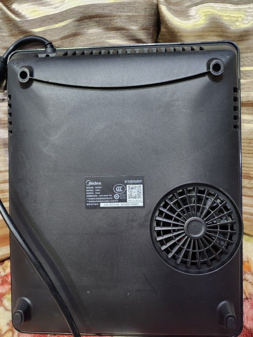 Midea Induction Cooker (Category: Cookers) located in Baguio. Submitted by alonasteph (Listing ID 1409954002, Image 3). Description: - Midea induction cooker - Black surface with circular heating area - Control panel with various settings - Includes power cord - Cooling fan for efficient operation - Model number clearly visible - In good working condition.