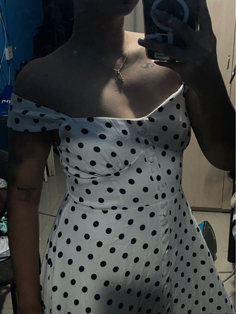 Polka Dot Two Way Off-Shoulder Dress (Category: Dresses) located in Pateros City. Submitted by nixoleil (Listing ID 1409886537, Image 2). Description: - Polka Dot Two Way Off-Shoulder Dress - White dress with black polka dots - Off-shoulder design - Button-down front - Fitted bodice - Flared skirt - Sweetheart neckline - Adjustable straps - Made of lightweight fabric - Fits Medium to Semi-Large - Perfect for Christmas - Long dress .