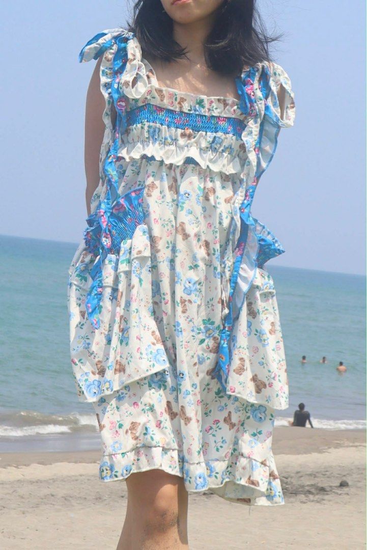 Printed beach dress (Category: Dresses) located in San Juan City. Submitted by prelovedstuff_01 (Listing ID 1409936179, Image 2). Description: Perfect for beach outings, garden parties, birthdays, daytime events, casual dates, or summer vacations. Fit & Size: Fits XS–M • Stretchy smocked bodice adapts to different body types • Adjustable straps and side ties for flexible styling and fit • Flowy layered skirt for comfort and movement.