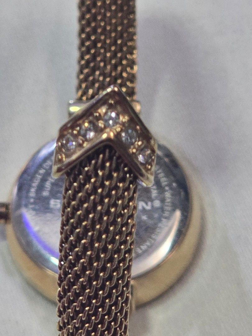 Skagen Denmark Gold Watch with Mesh Strap (Category: Women's Watches) located in Puerto Princesa. Submitted by eunizzie (Listing ID 1409982172, Image 3). Description: - Skagen Denmark watch - Gold-toned mesh strap - Round face with mother-of-pearl effect - Adorned with small crystals - Steel back - Decorative crystals on strap - Stylish accessory.