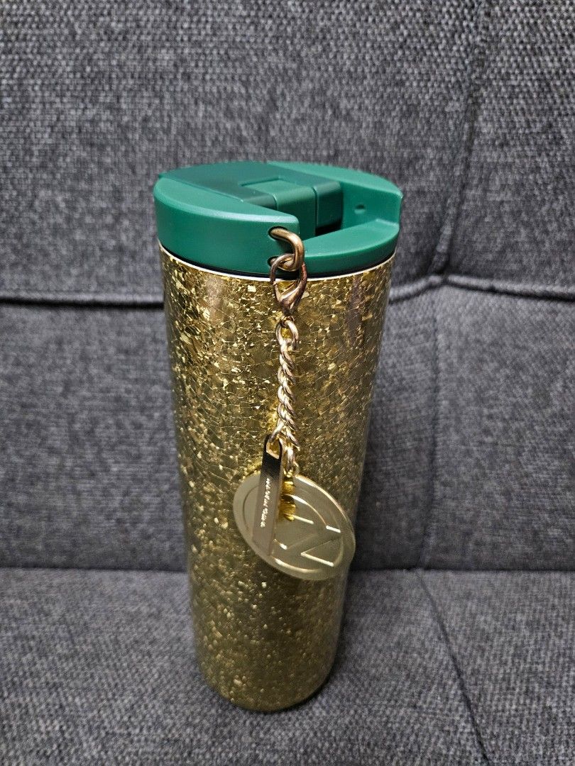 Starbucks Wicked Tumbler (Category: Water Bottles & Tumblers) located in Quezon City. Submitted by petite_kopichesg (Listing ID 1409819308, Image 1). Description: - Starbucks + Wicked tumbler with gold glitter design - Features a green lid - Includes a gold charm and chain - "Wicked + Starbucks" logo - Clean interior - Excess / Declutter - All sales are final - No return, no refund - Will not release item, if not yet paid .