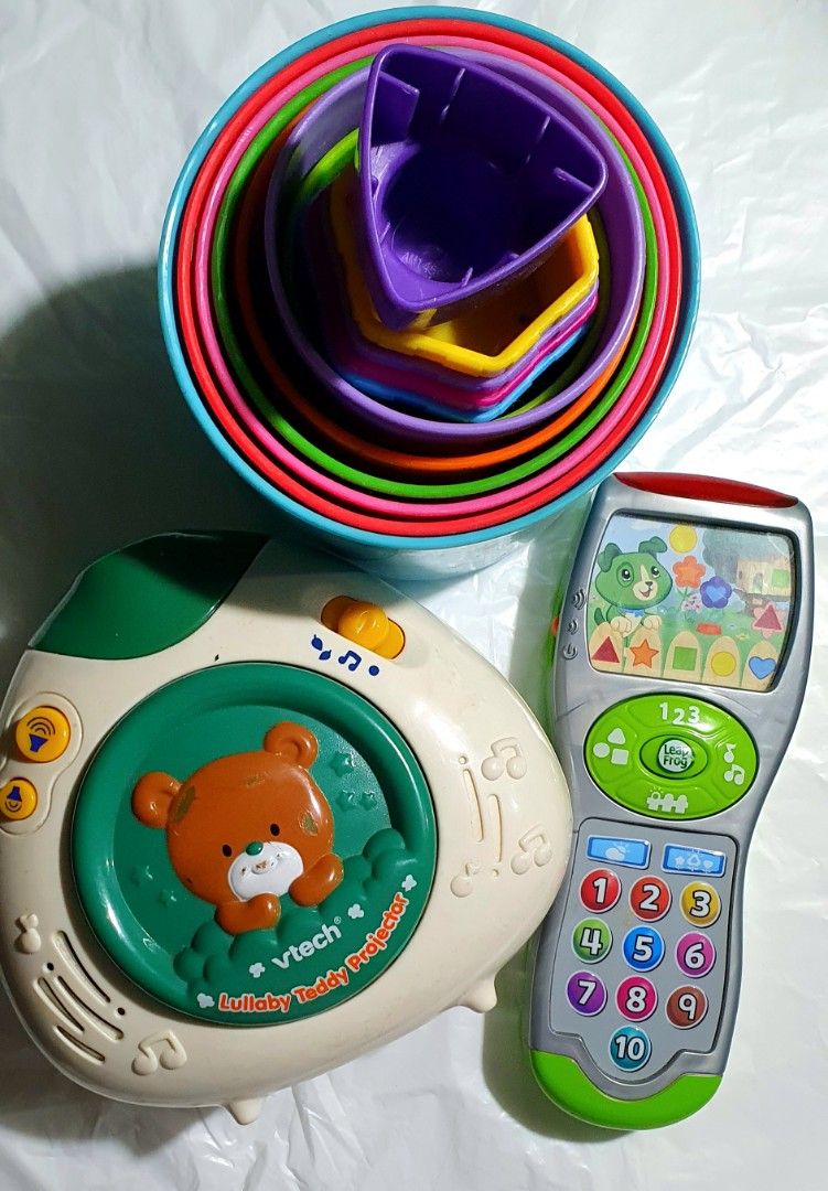 VTech Lullaby Teddy Projector & LeapFrog Phone Set (Category: Educational & Learning Toys) located in Cainta. Submitted by origeetostore (Listing ID 1409944963, Image 1). Description: Bundle of baby toys: VTech Lullaby Teddy Projector, LeapFrog phone, and stacking cups. Projector projects a green light. Phone has number buttons. Great for babies! All in good condition *battery operated Buyer will handle booking and delivery fee..