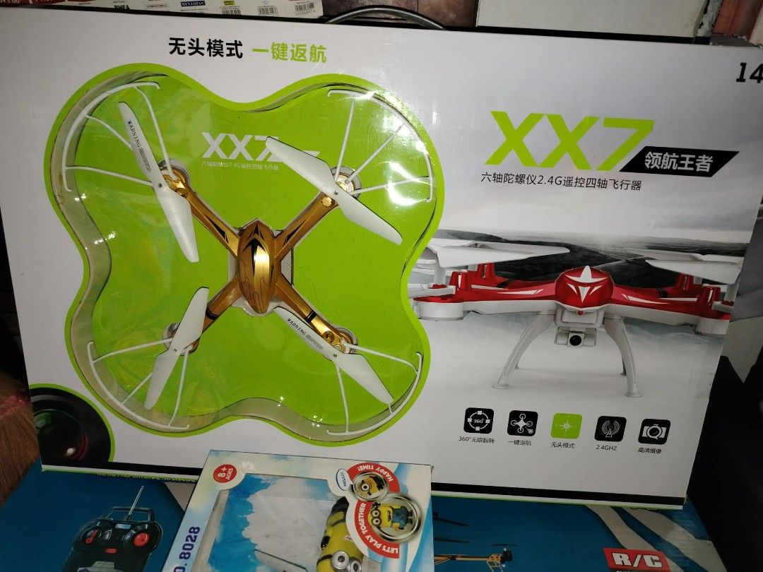 XX7 Drone with Camera (Category: Drones) located in Caloocan City. Submitted by youngdog_7a3ee7 (Listing ID 1409940353, Image 1). Description: XX7 drone features a headless mode and one-key return. It includes a camera and is a 2.4G quadcopter. The box shows the drone's design and features. It also comes with a remote control. The drone is red and white in color..