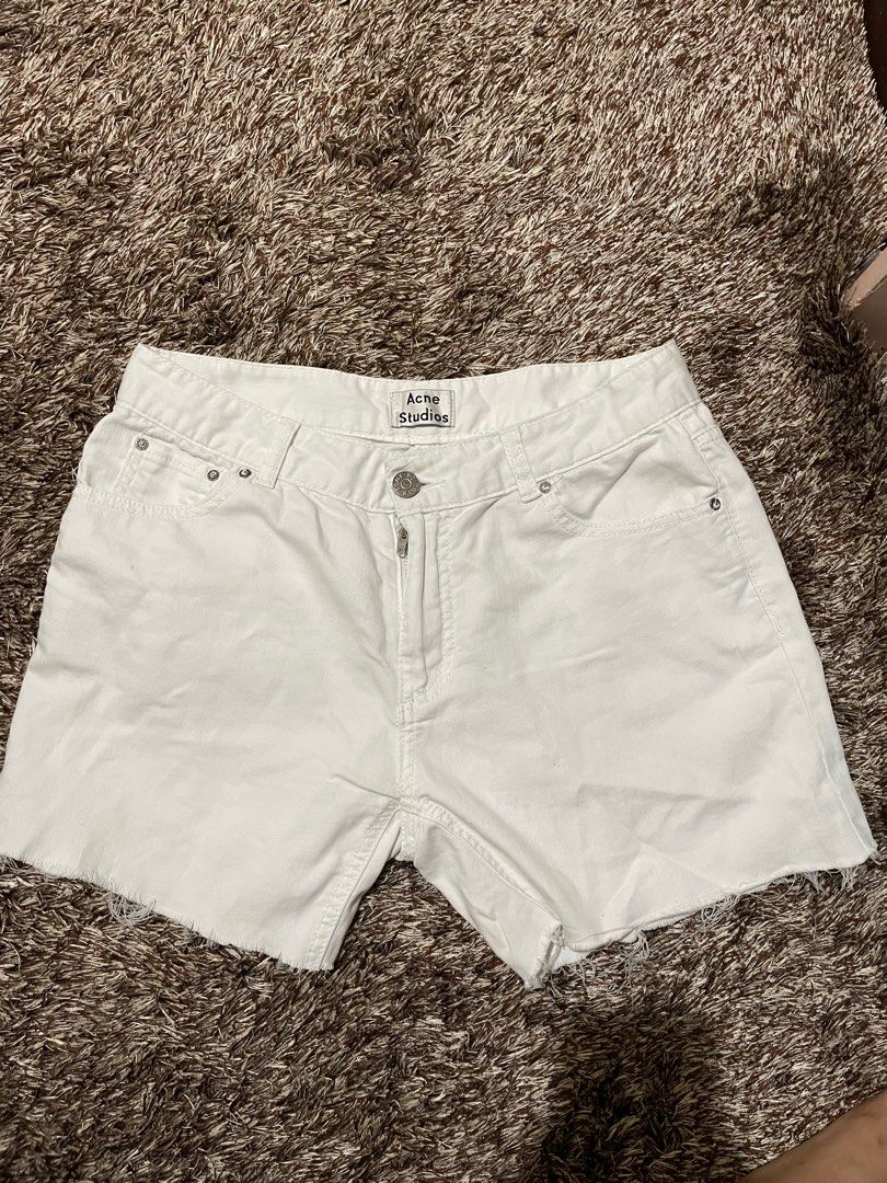 Acne Studios White Denim Shorts (Category: Shorts) located in Manila. Submitted by prelovedbymissp (Listing ID 1410109614, Image 1). Description: - Acne Studios white denim shorts - Button and zipper closure - Classic five-pocket design - Raw hem - Regular fit - Acne Studios logo on waistband.