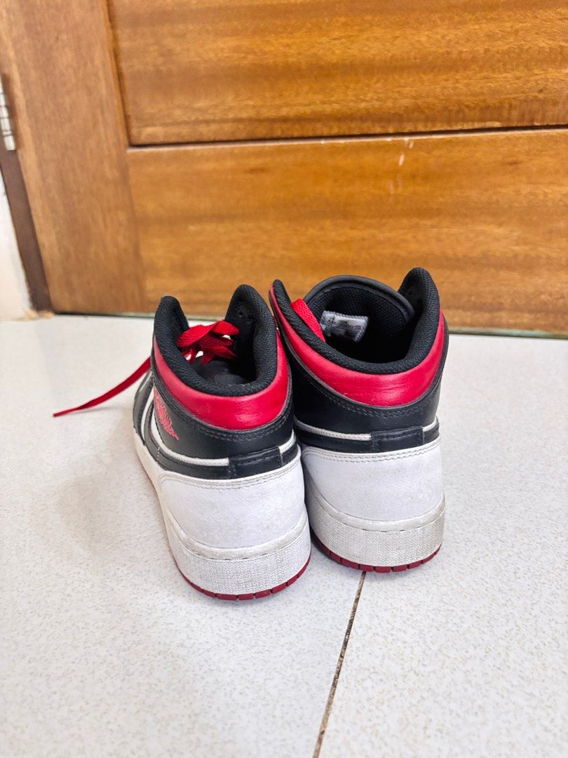 Air Jordan 1 Mid Black Red White (Category: Sneakers) located in Rizal. Submitted by allyowww (Listing ID 1410068709, Image 3). Description: - Air Jordan 1 Mid sneakers - Color: Black, red, and white - Features the Air Jordan logo - Red laces - White midsole - Black collar - White toe box - Signs of wear on soles.