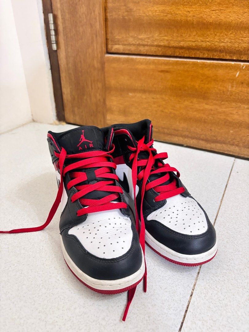 Air Jordan 1 Mid Black Red White (Category: Sneakers) located in Rizal. Submitted by allyowww (Listing ID 1410068709, Image 1). Description: - Air Jordan 1 Mid sneakers - Color: Black, red, and white - Features the Air Jordan logo - Red laces - White midsole - Black collar - White toe box - Signs of wear on soles.