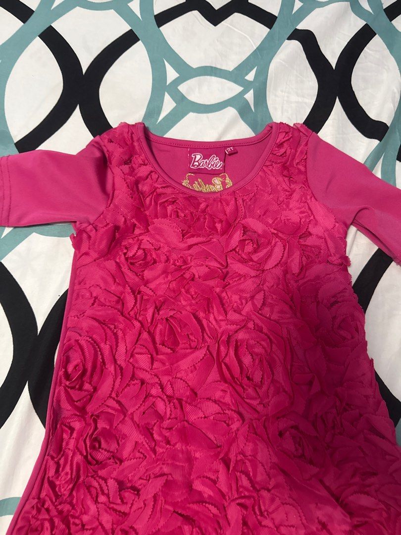 Barbie Pink Rose Dress (Category: Babies & Kids Fashion) located in Bacoor. Submitted by rizza_455 (Listing ID 1410092475, Image 2). Description: - Pink Barbie dress - Features a unique rose-like texture - Short sleeves - Round neckline - Made of soft material.