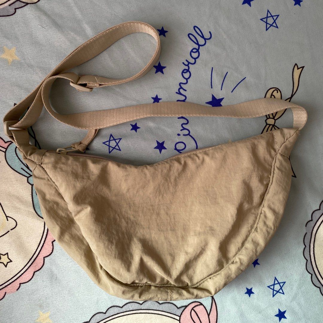 Beige Sling Dumpling Bag with Adjustable Strap (Category: Cross-body Bags) located in Taguig. Submitted by anndefined (Listing ID 1410005599, Image 1). Description: - not branded, bought from Sho pee.