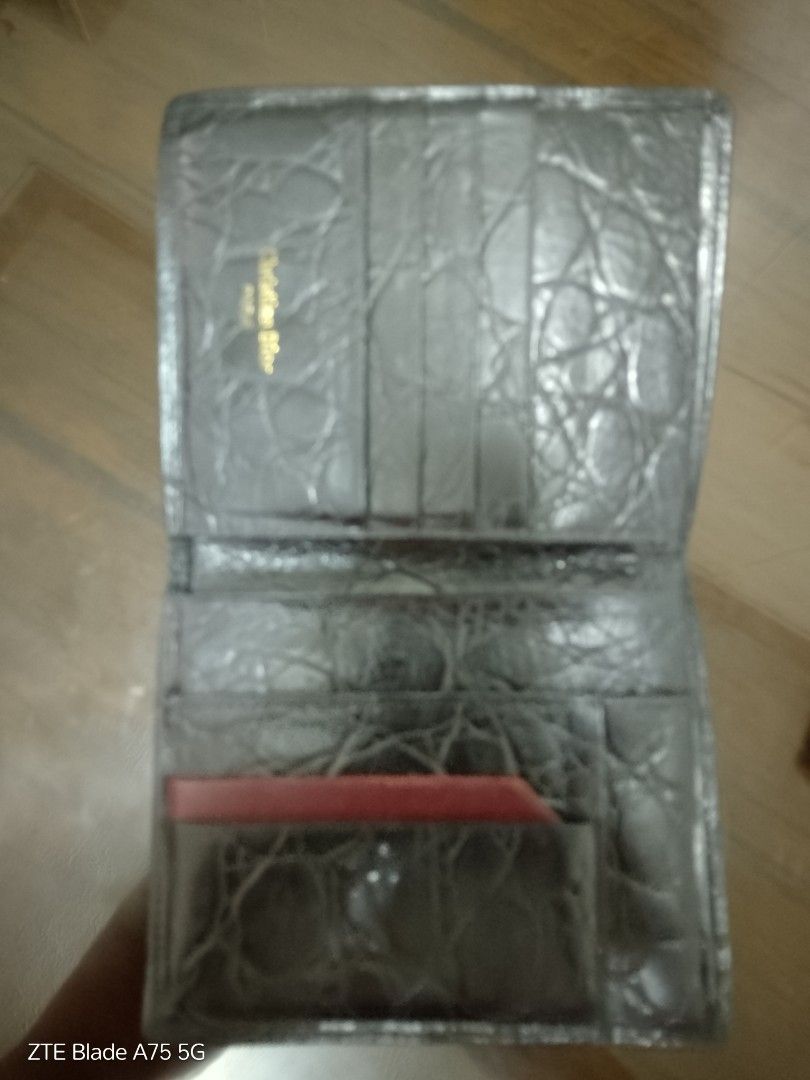 Christian Dior Black Leather Wallet (Category: Luxury Bags & Wallets) located in Manila. Submitted by _bueta.09 (Listing ID 1410037150, Image 2). Description: Christian Dior black leather wallet. Features multiple card slots, compartments, and a red card holder. Dior logo is visible..