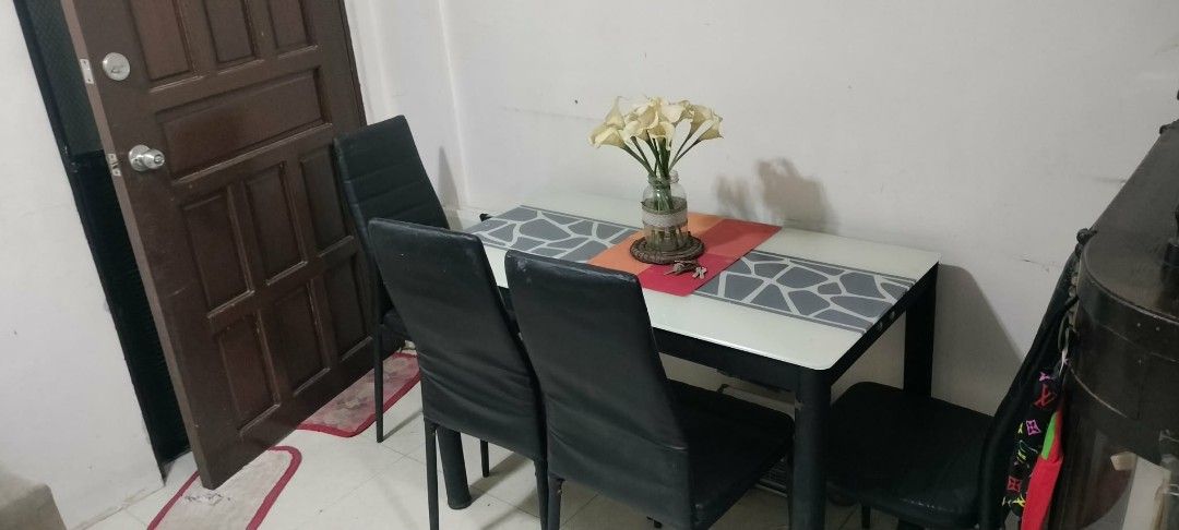 Dining Table with 4 Chairs (Category: Tables & Sets) located in Rodriguez. Submitted by swiftwolf-dfd7eb (Listing ID 1410076400, Image 3). Description: I buy my dining table amount 15k plus but I selling it for only 7500 I have a discount pa - Dining table with a white top and decorative gray center pattern. - Includes four black chairs. - Chairs feature black leather seats and backs. - Ideal for small dining areas..