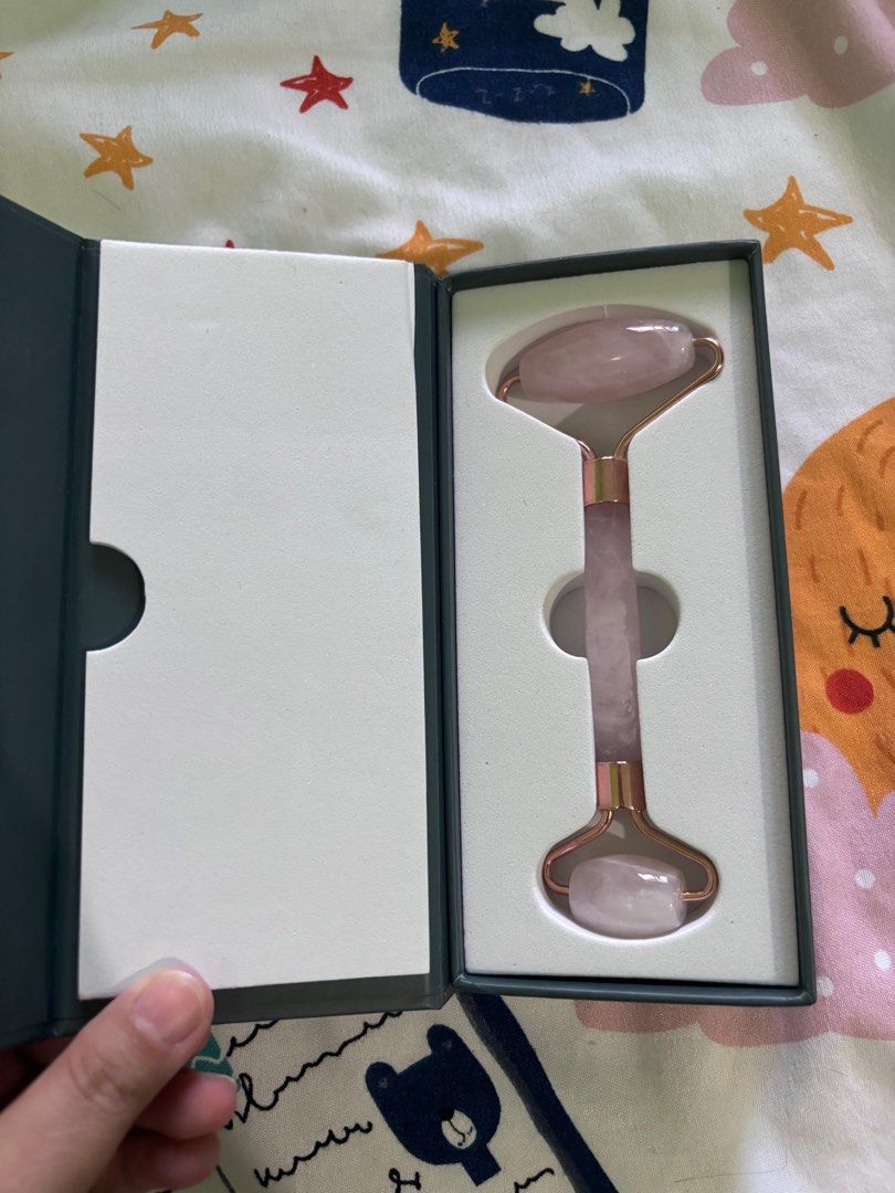 Greenika Premium Rose Quartz Face Roller (Category: Face Care) located in Rizal. Submitted by youronlineshoppe (Listing ID 1410060540, Image 1). Description: - Greenika Premium Rose Quartz Face Roller - Brand new, in original box - Designed for facial massage and relaxation - Features a rose gold frame - Comes in a dark teal box with gold lettering.