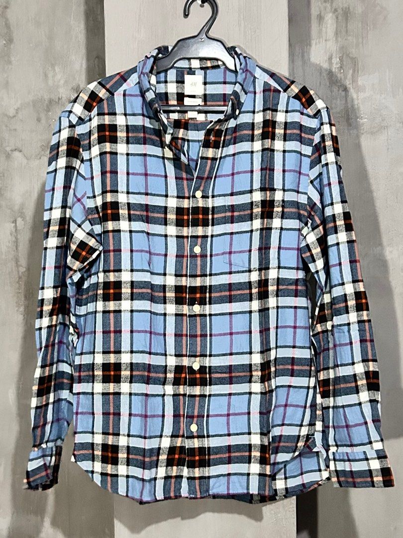 H&M Plaid Flannel Shirt (Category: Tshirts & Polo Shirts ) located in Pasay City. Submitted by inss1 (Listing ID 1410096697, Image 2). Description: - H&M blue plaid flannel shirt - Button-down collar - Long sleeves - Classic plaid pattern (blue, black, white, orange) - Buttoned cuffs - 17x28.