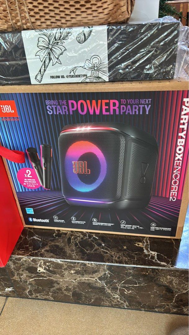 JBL PartyBox Encore 2 (Category: Soundbars, Speakers & Amplifiers) located in San Juan City. Submitted by kitsugi (Listing ID 1410086031, Image 1). Description: Bring the star power to your next party with the JBL PartyBox Encore 2. This speaker includes two wireless microphones for karaoke. It features Bluetooth connectivity and colorful lighting effects. The box shows the JBL logo and the model name. It is a portable speaker designed for partie